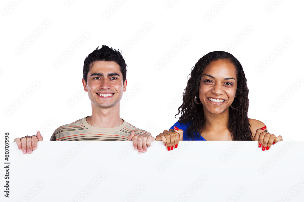 Multiracial couple holding a blank banner Multiracial couple holding a blank banner