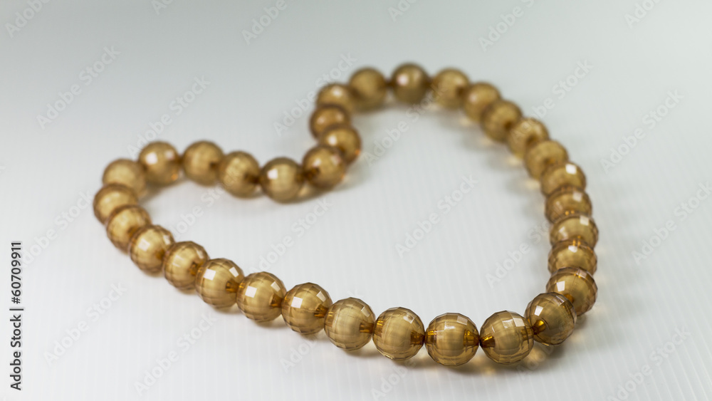 Heart shaped bead necklace brown Isolated on white background Heart shaped bead necklace brown Isolated on white background