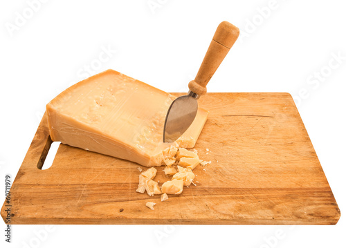 Parmesan cheese with knife on old wooden board, isolated over wh