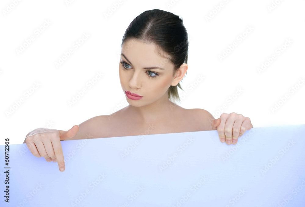 Beautiful woman pointing to a blank sign Beautiful woman pointing to a blank sign