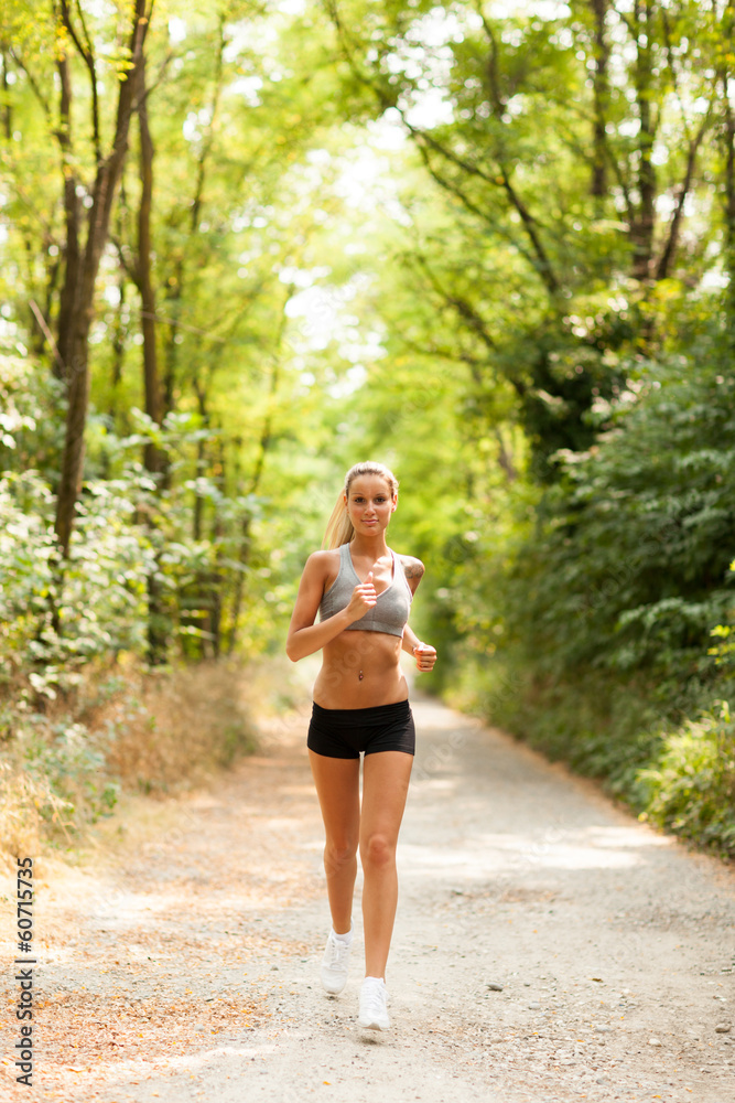 Beautiful blonde woman is doing running workout Beautiful blonde woman is doing running workout