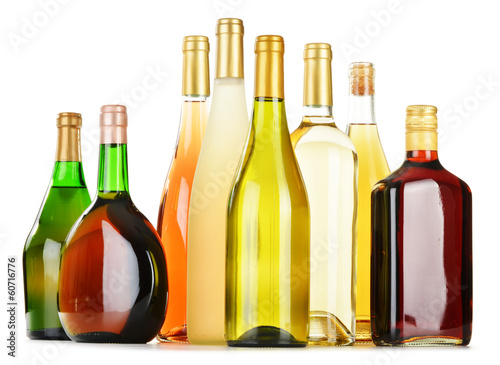 Bottles of assorted alcoholic beverages isolated on white