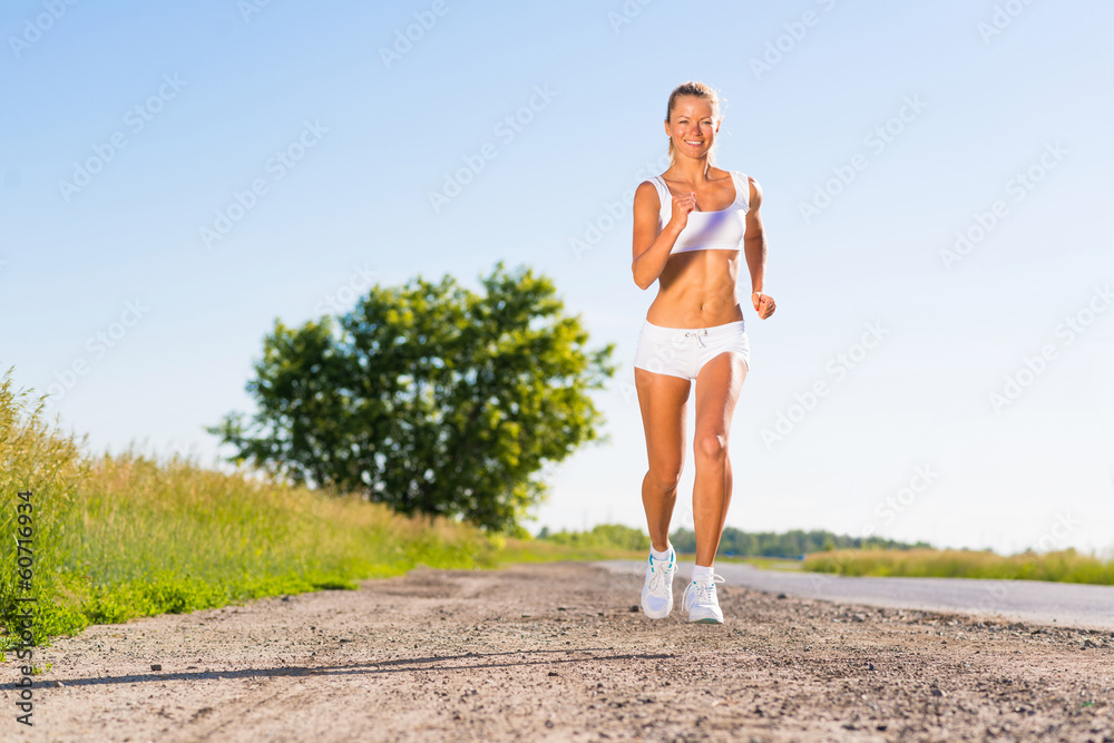 young athletic woman running on the road young athletic woman running on the road
