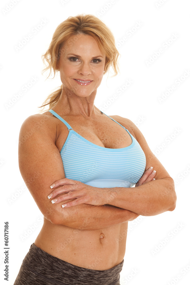 Mature woman blue bra arms folded Stock Photo