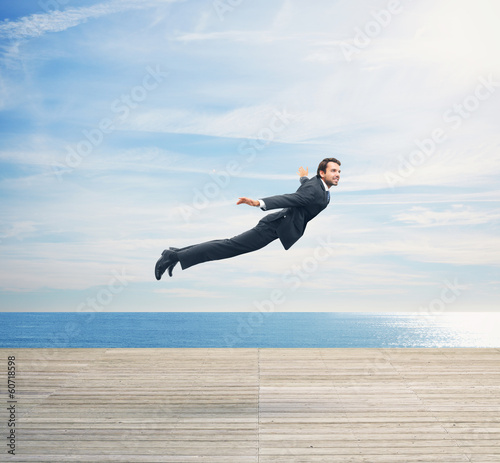 Tela Man in suit flying over boardwalk