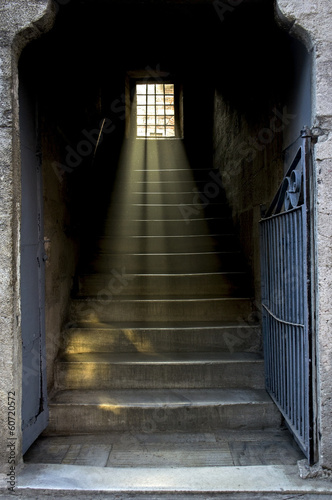 Staircase with light shining through window