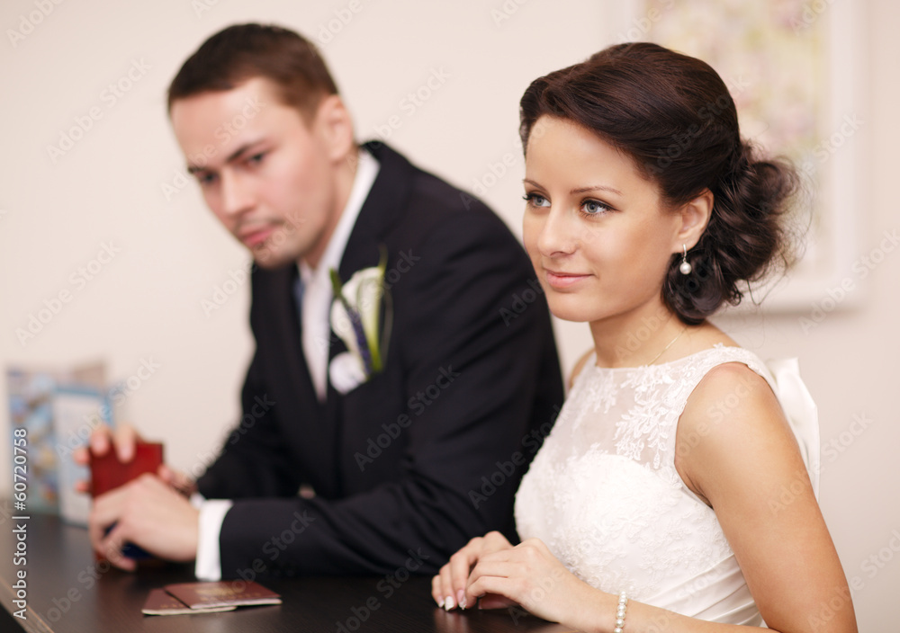 Couple at a reception desk with their passports Couple at a reception desk with their passports