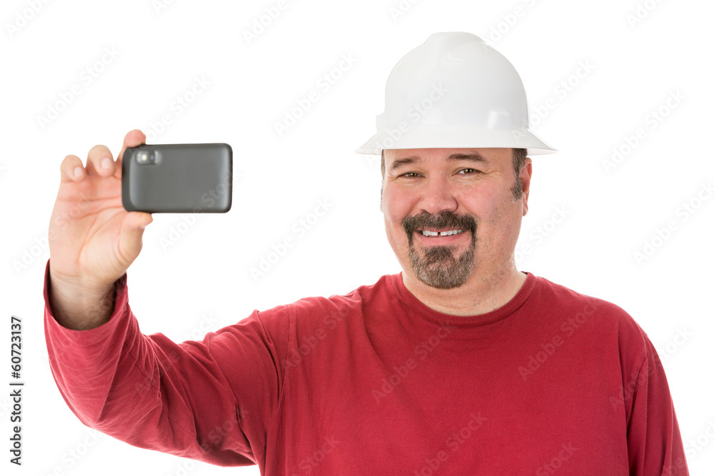 Smiling workman taking a self-portrait Smiling workman taking a self-portrait