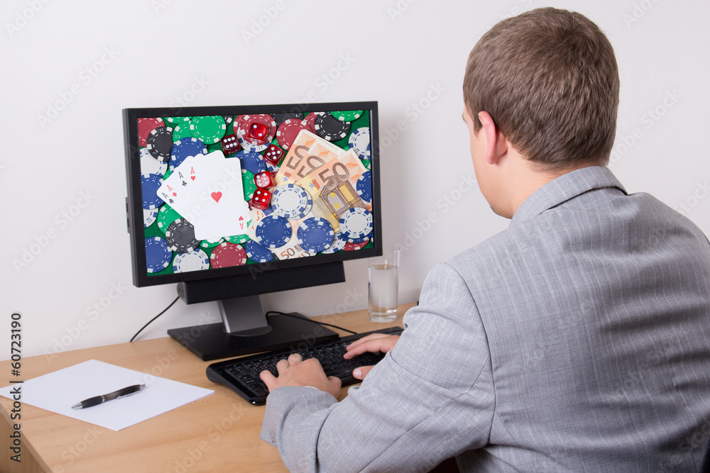 young man in suit playing poker in internet young man in suit playing poker in internet