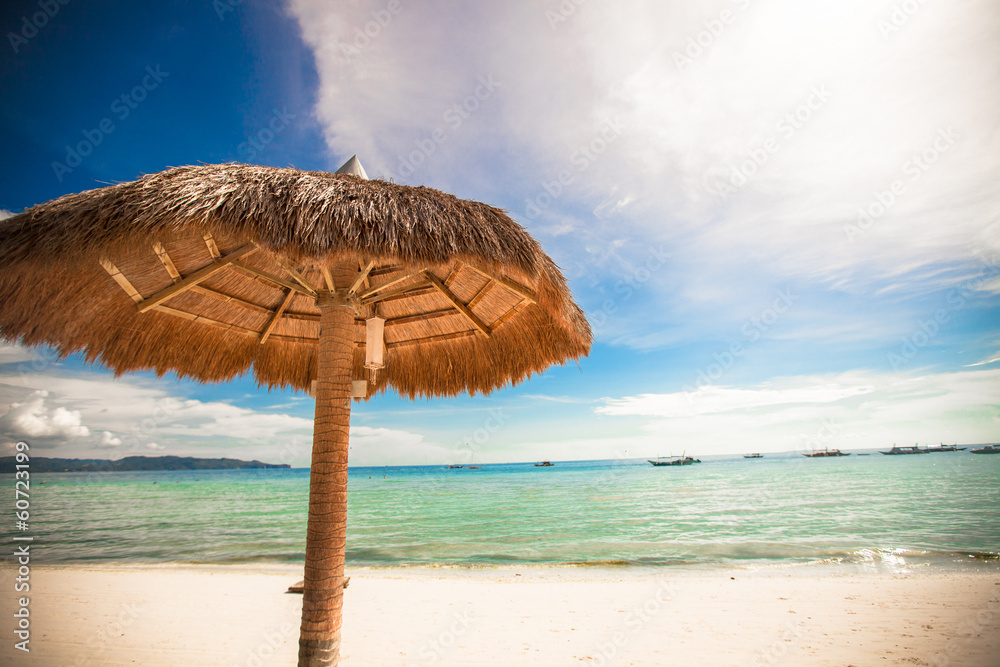 Straw umbrella on a tropical beach