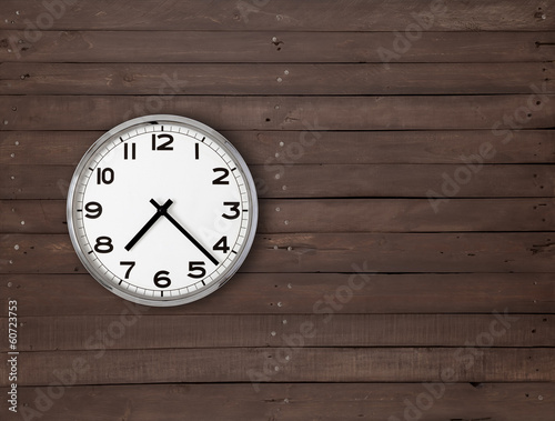 Clock on a brown wooden wall
