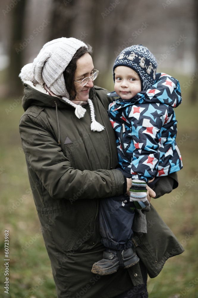 Woman holding her small son Woman holding her small son