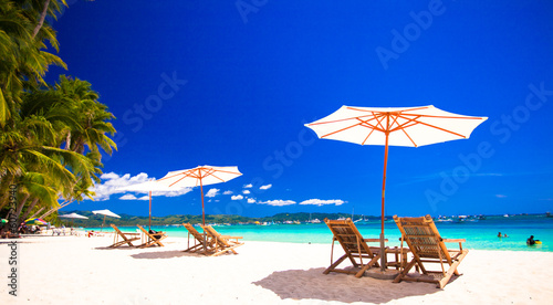 Fototapeta Naklejka Na Ścianę i Meble -  Paradise view of nice tropical empty sandy plage with umbrella