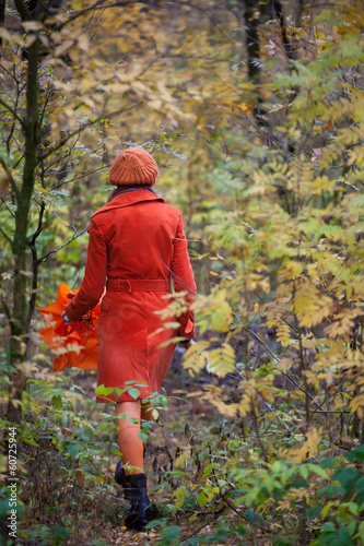 Girl in orange coat  and with orange umbrella in the autumn fore © Aleks Kend