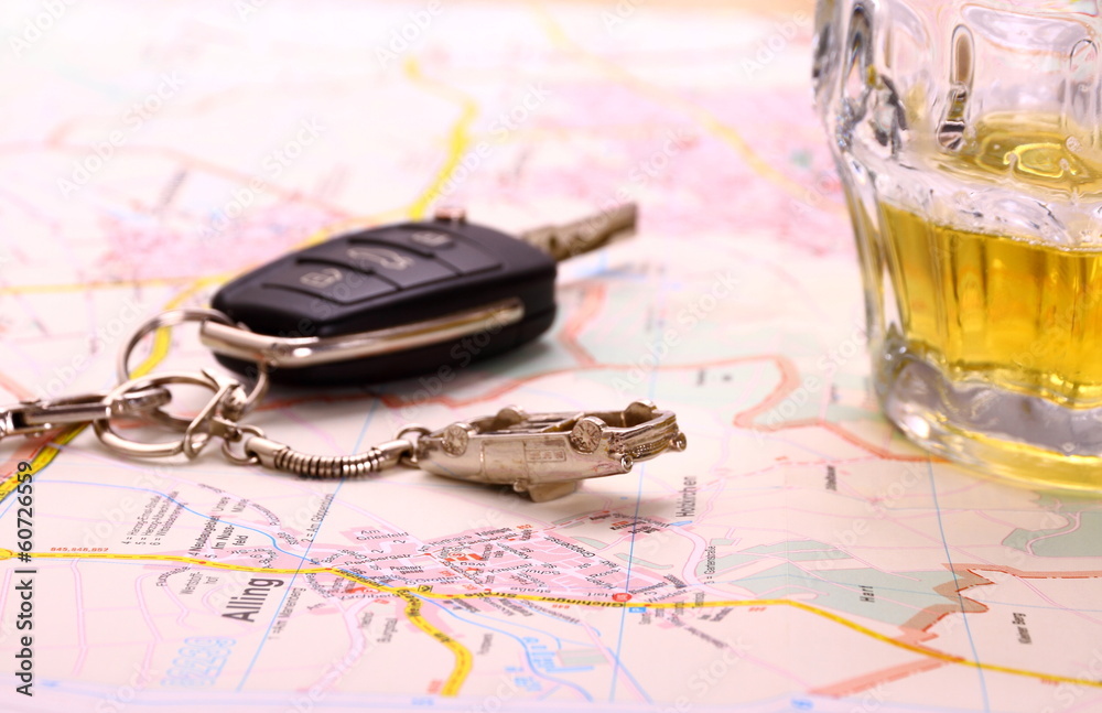 Car key with accident and beer mug on map