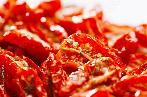 sun-dried tomatoes with olive oil, background, shallow dof © Elena Moiseeva