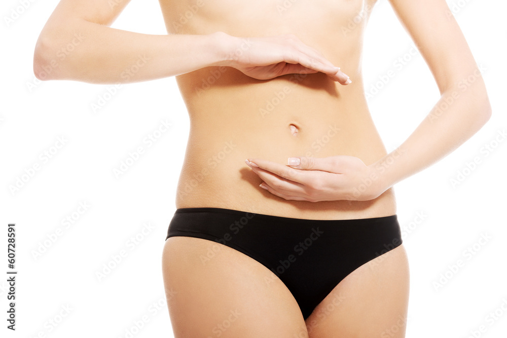 Caucasian woman is holding hand on her belly. Caucasian woman is holding hand on her belly.