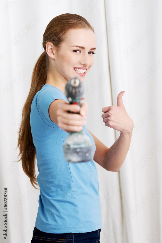 Casual beautiful house wife holding drill. Casual beautiful house wife holding drill.