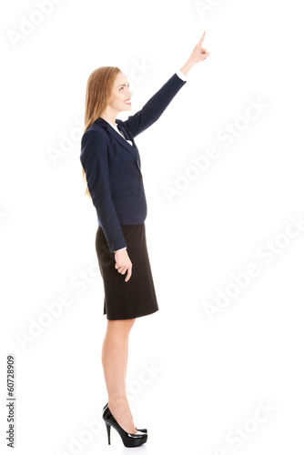 Beautiful business woman pointing on copy space.