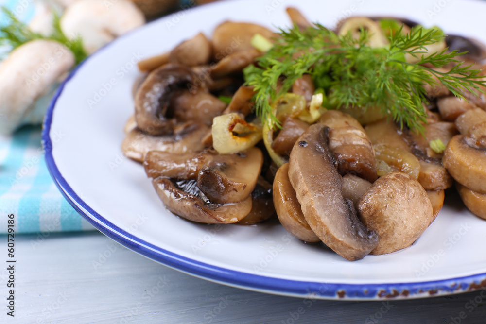 Delicious fried mushrooms on plate on table close-up Delicious fried mushrooms on plate on table close-up