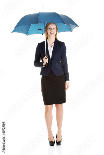 Beautiful caucasian business woman standing under umbrella.