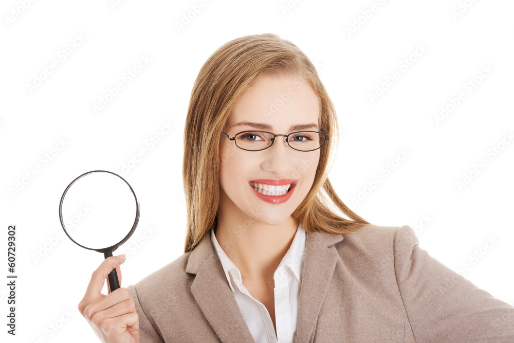 Beautiful caucasian business woman with magnifying glass. Beautiful caucasian business woman with magnifying glass.