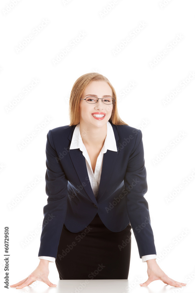 Beautiful business woman bending over table. Beautiful business woman bending over table.