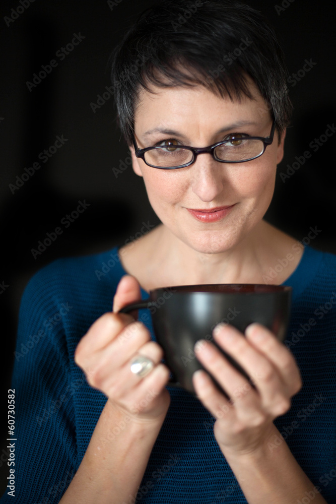 Beautiful Woman with Short Hair and Coffee Cup on Black Backgrou