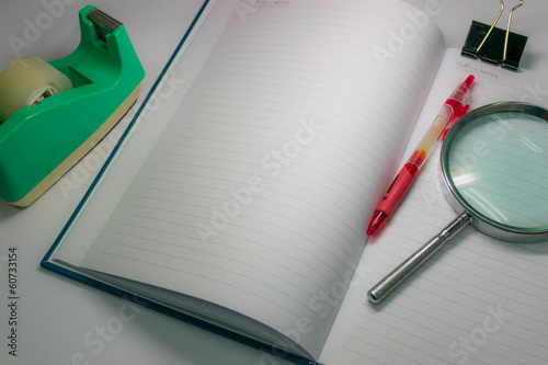 Still life notebook and stationery tools in dim light background