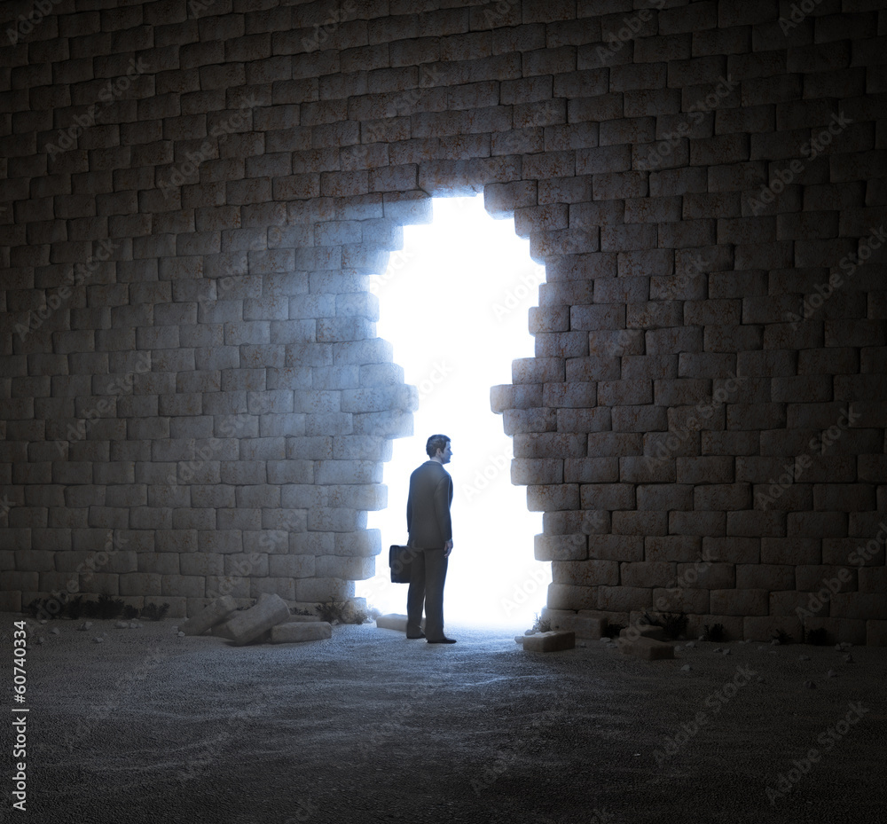 Businessman standing in a wall opening