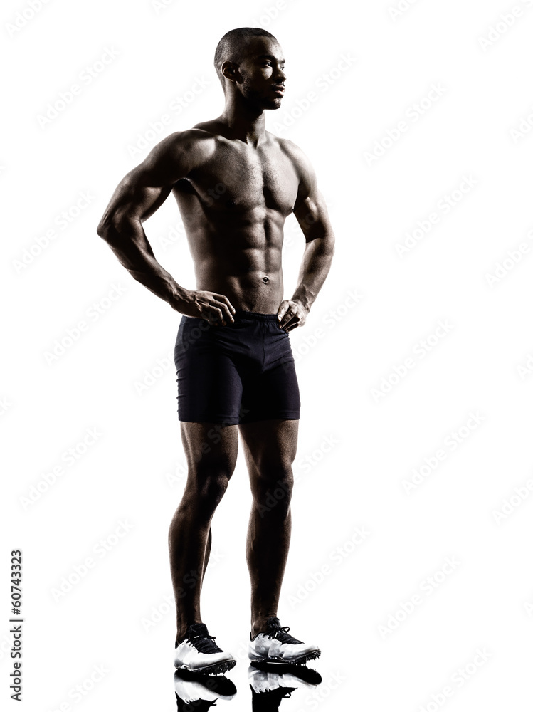 young african shirtless muscular build man standing silhouette