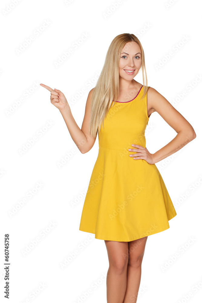 Young woman in yellow dress smiles and shows thumb. Young woman in yellow dress smiles and shows thumb.