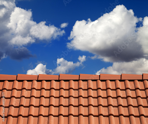 Roof tiles and cloudy sky