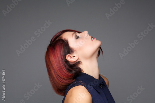 Young woman with modern hairstyle looking up