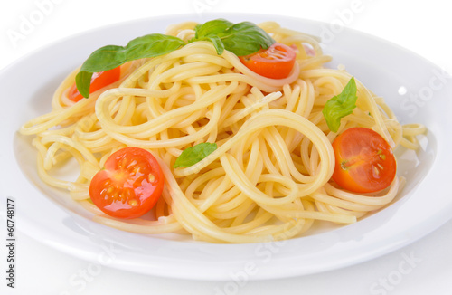 Delicious spaghetti with tomatoes on plate close-up