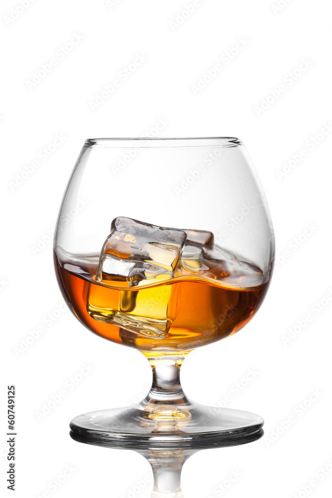 Splash of whiskey with ice in glass isolated on white background Splash of whiskey with ice in glass isolated on white background