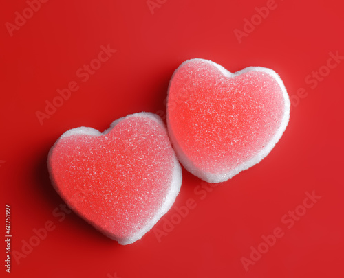 Sugar hearts on red background