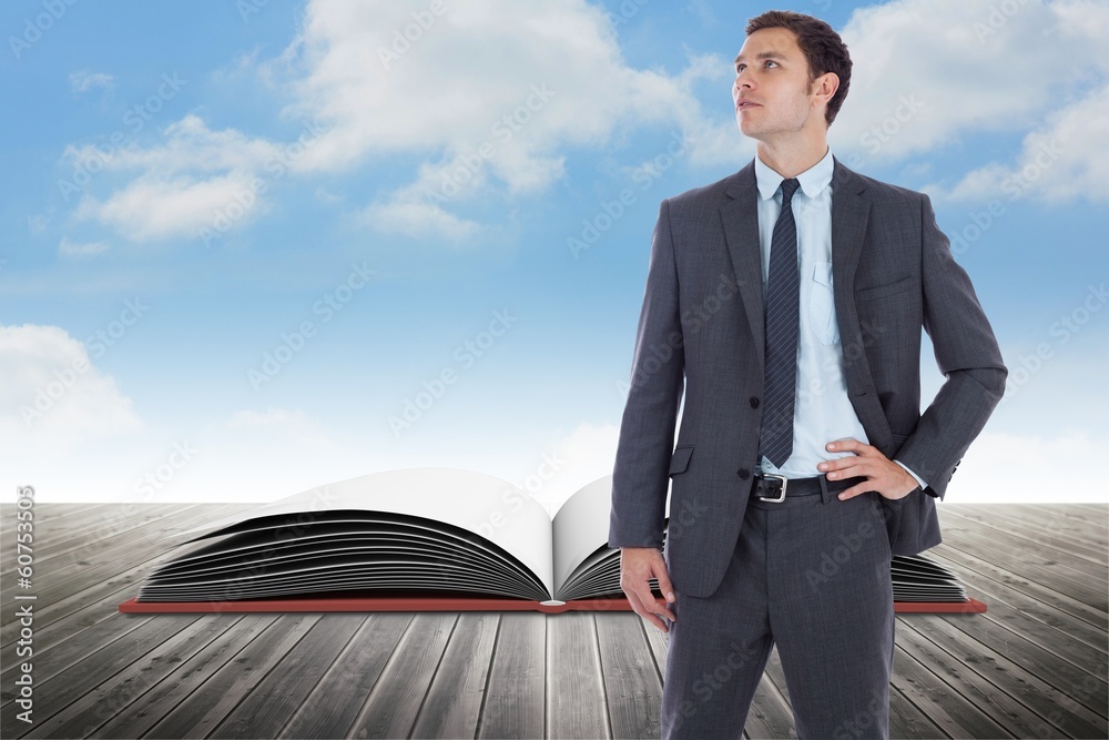 Composite image of serious businessman with hand on hip Composite image of serious businessman with hand on hip