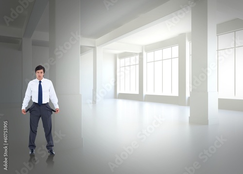 Composite image of sad tradesman showing his empty pockets