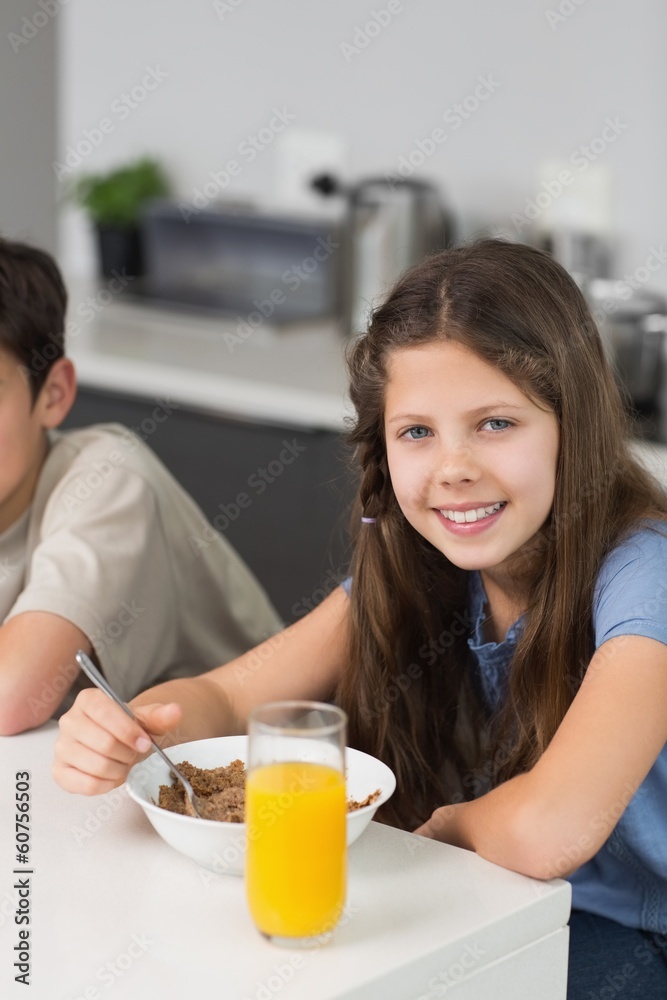 Portrait of two smiling siblings enjoying breakfast Portrait of two smiling siblings enjoying breakfast