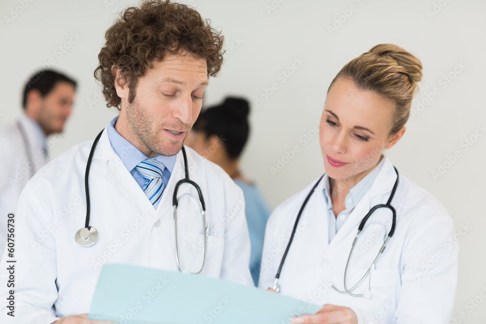 Medical team discussing over file Medical team discussing over file