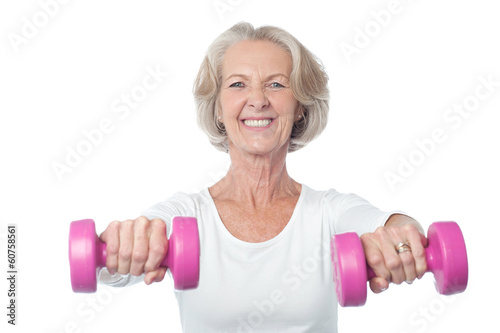 Happy aged woman exercising