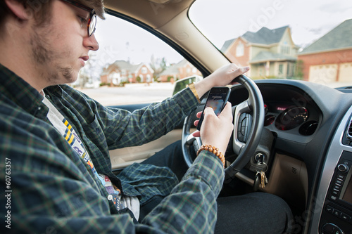 young man texting and driving distracted