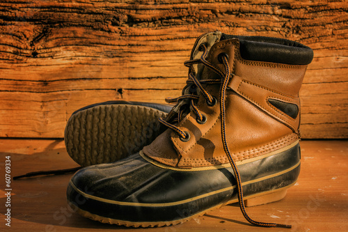 A pair of leather hiking boots on wooden floor