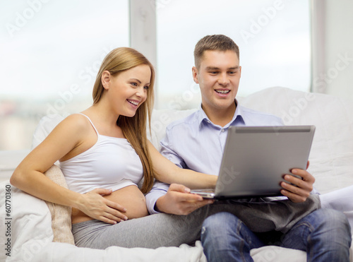 expecting family with laptop computer