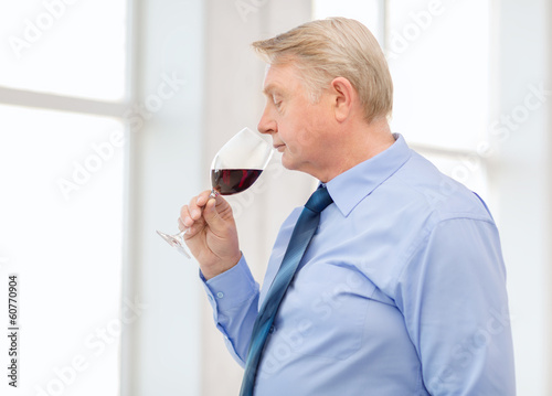 older man smelling red wine © Syda Productions