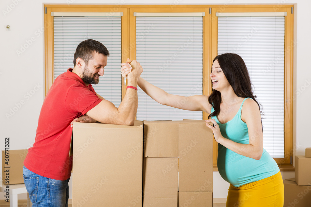 Pregnant mother and happy father in new house Pregnant mother and happy father in new house