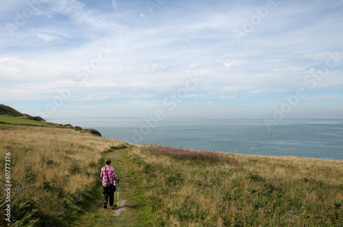 Obraz na płótnie Walker on coastal path above Cardigan Bay w salonie