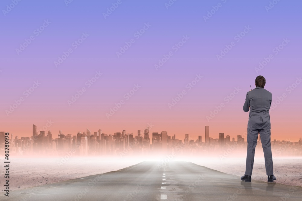 Composite image of thoughtful businessman holding pen Composite image of thoughtful businessman holding pen