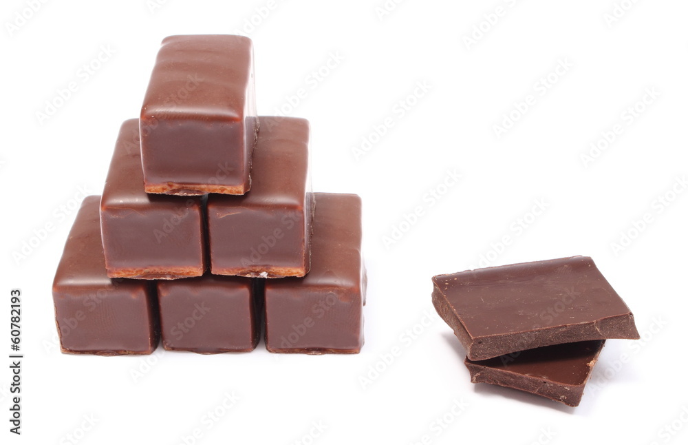 Candies and portion of chocolate on white background